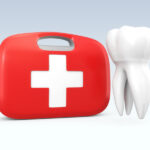 A tooth next to a red first aid kid to indicate a dental emergency